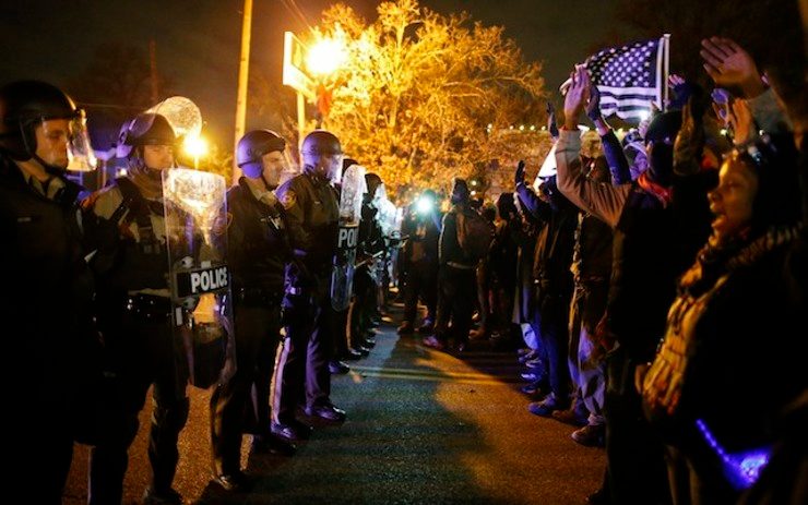 US VS THEM. Demonstrators face off against the police after the Grand Jury decision not to indict police officer Darren Wilson in shooting death of Michael Brown in Ferguson, Missouri, USA, 24 November 2014. Larry W. Smith/EPA