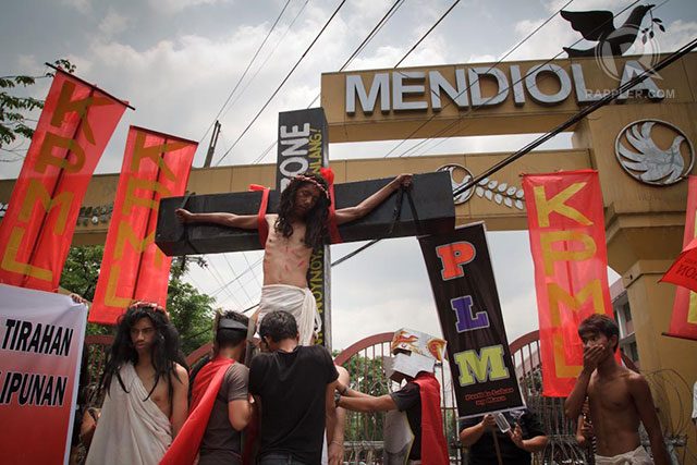 CRUCIFIXION. “Jesus” is nailed to the cross in Mendiola.