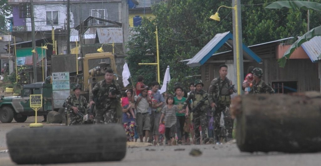 COMBAT ZONE. Ranger rescue a group of Marawi residents, mostly women and children, from the combat zone. Adrian Portugal/Rappler 