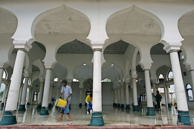 Structures that survived, like this mosque mosque at Peukan Bada on the outskirts of Banda Aceh, were cleaned.
