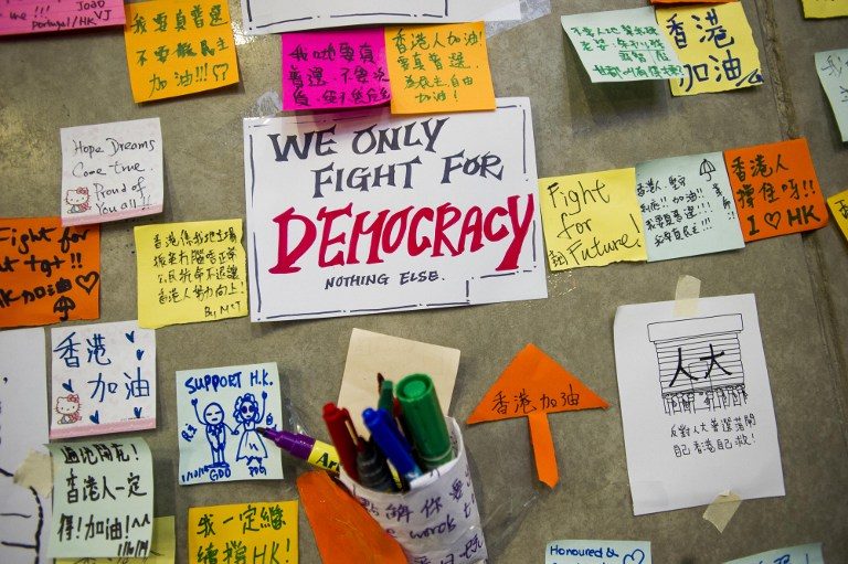 'FOR DEMOCRACY' Messages are stuck on the wall of the Legislative Counsel building in the Admiralty district of Hong Kong on October 2, 2014. Xaume Olleros/AFP