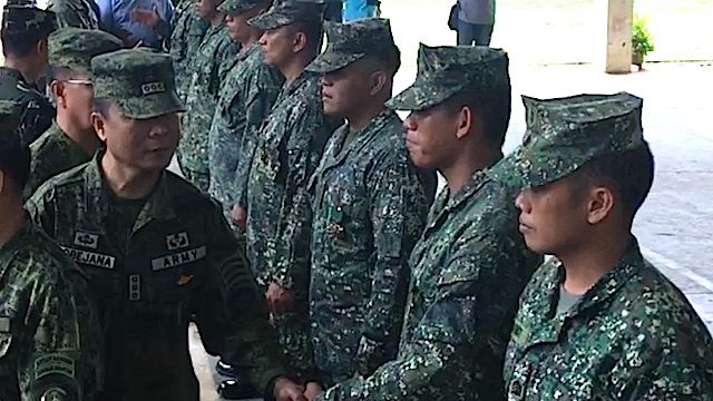 MILITARY MERIT MEDALS. Joint Task Force Sulu commander Colonel Cirilito Sobejana congratulates his men. Rappler photo 