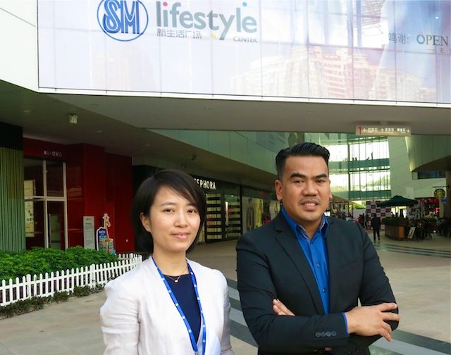 SM CHINA. Ronald Allan Brosas, SM Supermalls Assistant Vice President (right); and Lucy Xu, SM China regional operations manager, Shopping Center Management Division, in front of SM Xiamen. Photo by Mia Gonzalez/Rappler      