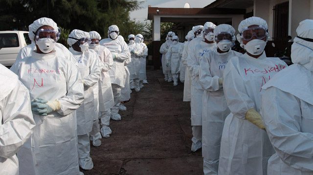 FIGHT CONTINUES. Health workers wearing personal protective equipment (PPE) outside a midwifery school where they are attending a training session on Ebola, in Makeni, Sierra Leone. Photo courtesy: UNICEF/John James
