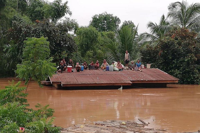 DAM DISASTER. Residents on rooftops surrounded by floodwaters in Attapeu province in Laos after a dam collapsed on July 23, 2018. Photo by Attapeu Today/AFP  