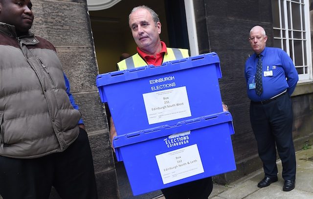 Ballot boxes are carried to vans at a depot in Edinburgh, Scotland, 17 September 2014 on the eve of the Scottish independence referendum. Andy Rain/EPA
