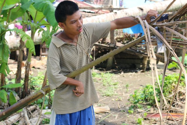 DIFFERENTLY ABLED. Jimboy is known in his community for his love for his 70-year old grandmother. Despite physical challenges, he collects firewood and cleans the house just to help. Photo by Cristie Macabe/World Vision