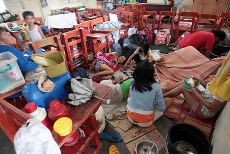 RESTLESS NIGHT. Families set up temporary sleeping areas in a school in Marikina in anticipation of heavy rain Monday night. Photo by Ben Nabong/Rappler