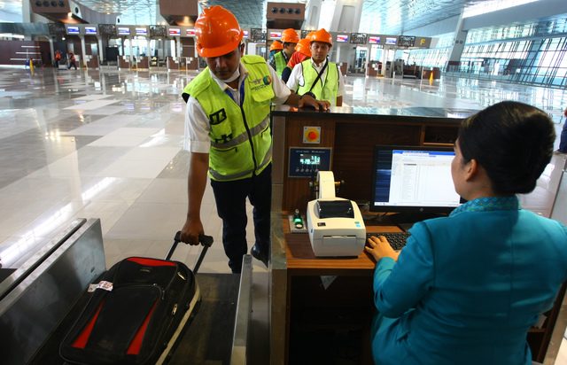 Petugas memeriksa tiket pesawat calon penumpang saat simulasi pengoperasian Terminal 3 Ultimate Bandara Soekarno Hatta, Tangerang, Banten, pada 12 Juni 2016. Foto oleh Muhammad Iqbal/Antara 