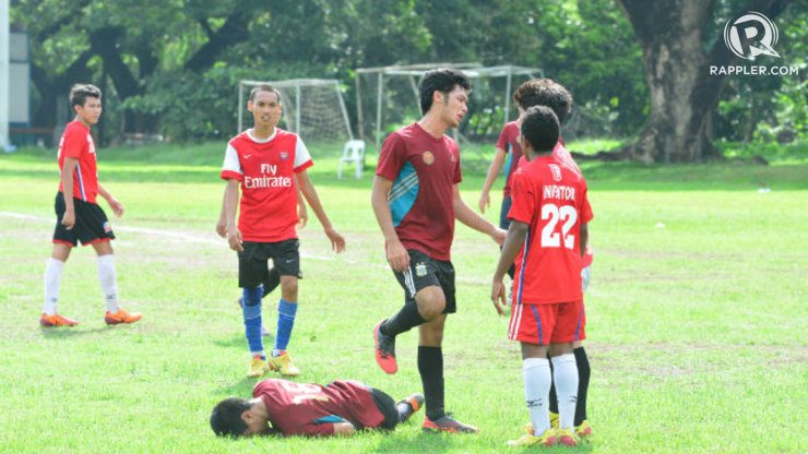 A UP player is down after a late game scuffle with an EAC player. Photo by Nevin Reyes/Rappler