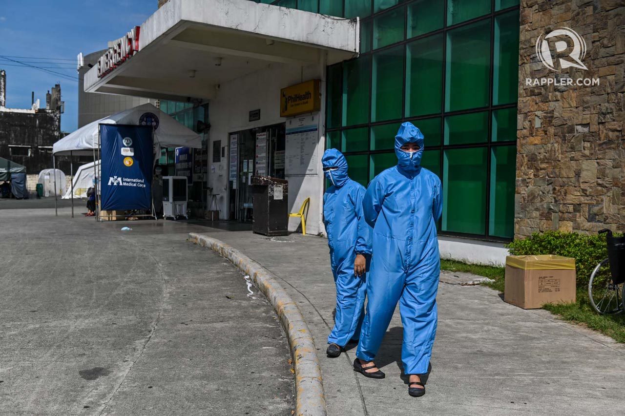 WORK AS USUAL. Medical workers in full protective gear wait for the simple anniversary celebration to begin. Photo by Alecs Ongcal/Rappler 
