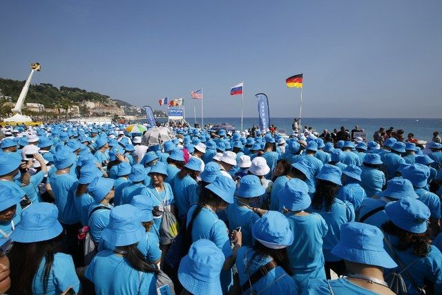 EN MASSE. Employees of Chinese company 'Tiens' attend a parade on May 8, 2015 in Nice organized by 'Tiens' CEO Li Jinyuan as part of the two-days celebration weekend for the 20th anniversary of his company in which he invited 6,400 of his employees. File photo by Valery Hache / Agence France-Presse  