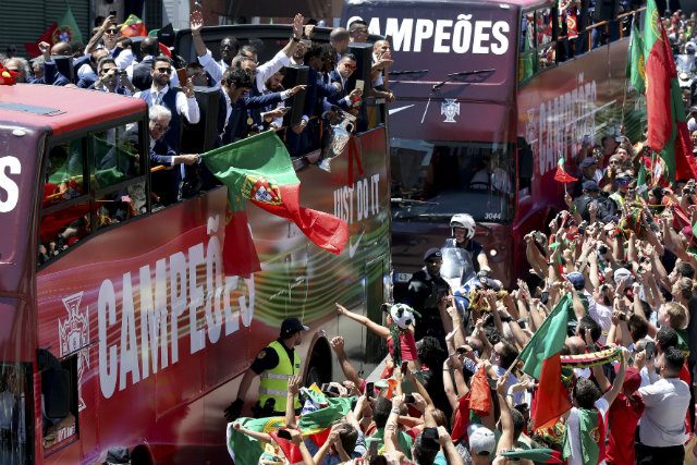 VICTORY PARADE. Players of the Portuguese national team on an open-top bus celebrate with supporters along the streets of Lisbon, Portugal, 11 July 2016. EPA/SETVEN GOVERNO 