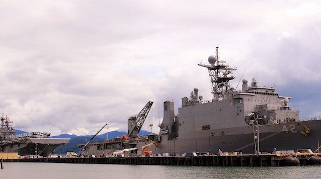 LANDING SHIPS. The dock landing ship USS Germantown (right) and the assault ship USS Bonhomme Richard occupy the length of the Alava Pier in the Subic Bay Freeport on Wednesday. The ships, along with USS Green Bay, are in port for replenishment before participating in the ongoing war maneuver between the Philippines and the United States.  