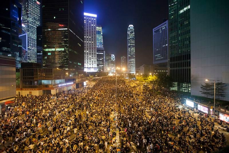 HONG KONG CENTRAL, OCCUPIED. Pro-democracy protesters gather outside the Hong Kong government headquarters, on the second day of the mass civil disobedience campaign Occupy Central, Central District, Hong Kong, China, September 29, 2014. Alex Hofford/EPA