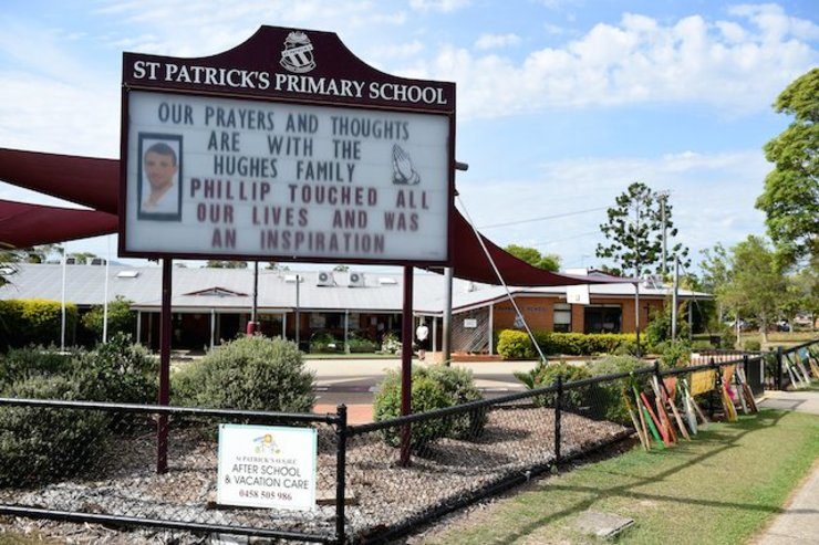 TRIBUTE. Cricket bats are seen on the front fence of St Patricks Primary school, as a tribute to former student Phillip Hughes, in Macksville, Australia, 03 December 2014. Dan Himbrechts/EPA