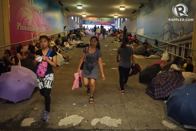 OVER-UNDER. When the rains hit Hong Kong on Sundays, or when the sun is too hot to bear, Filipino domestic workers find their place in pedestrian underpasses. Photo by George Moya/Rappler 
