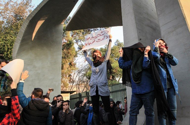 10 dead in overnight Iran unrest as Rouhani strikes defiant note