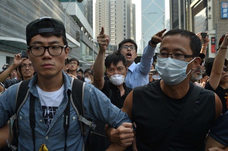 Clashes as masked men rush Hong Kong protest barricades