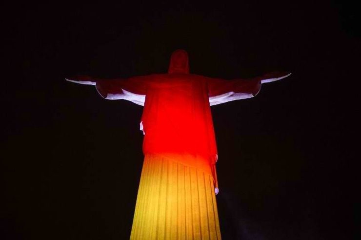The statue of Christ the Redeemer is illuminated in the colors of Germany's national flag atop Corcovado hill in Rio de Janeiro after the team's World Cup victory. Photo by Yasuyoshi Chiba/AFP