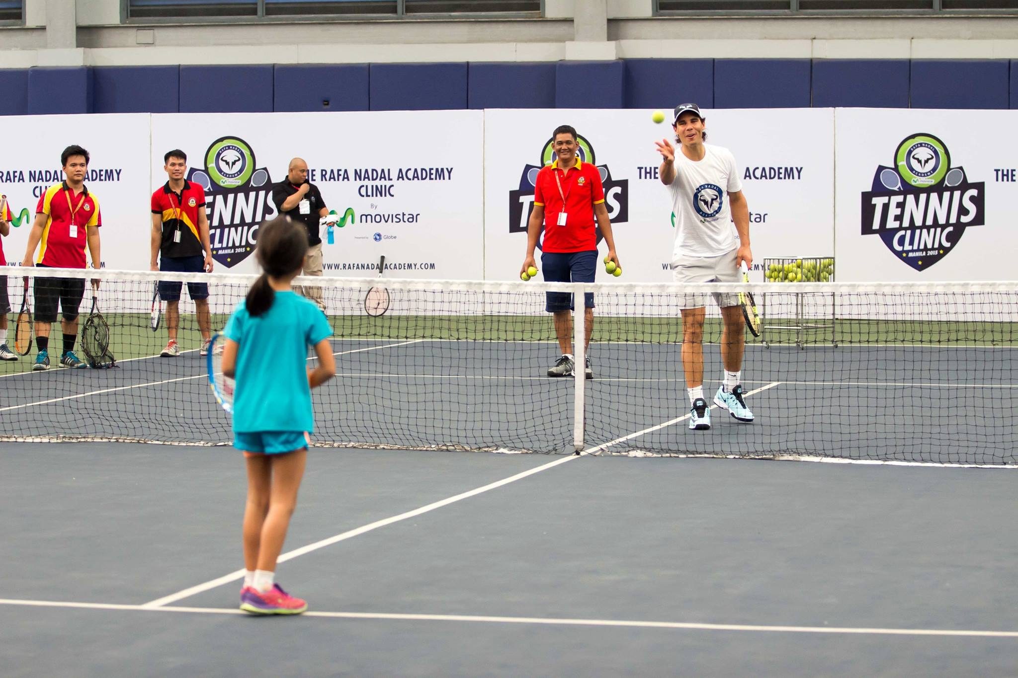 NADAL IN MANILA. Rafa Nadal takes his time teaching a young student. Photo by Ena Terol/Rappler  