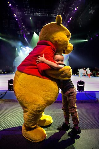 WARM WELCOME. Winnie the Pooh gives hugs to the kids before the show. Photo from release 