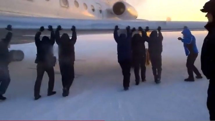 People power: Passengers push frozen Siberian plane