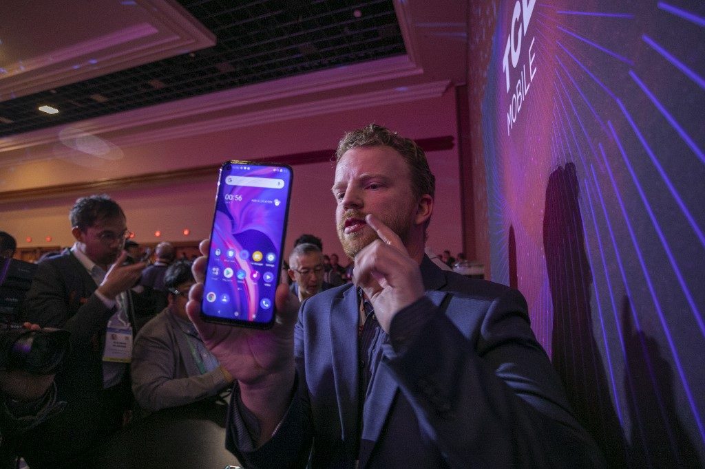TCL. A man holds a new TCL 10 series phone at the TCL news event during the 2020 Consumer Electronics Show (CES) in Las Vegas, Nevada, on January 6, 2020. Photo by David Mcnew/AFP 