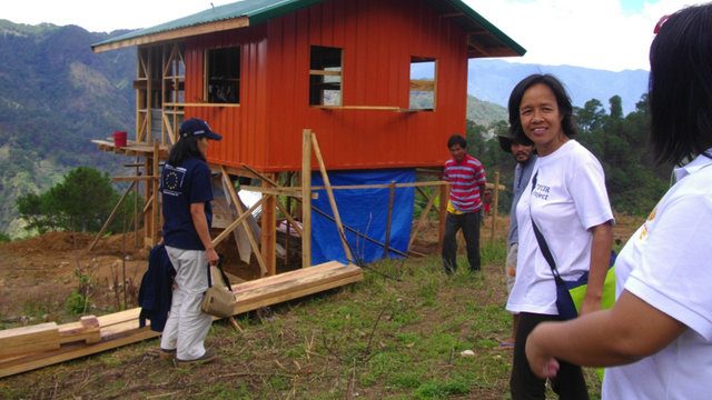 BUILDER. Engineer Delle Salvador (second from right) during their shelter reconstruction response to Typhoon Pepeng in 2009. (Photo from Gawad Bayani ng Kalikasan)  