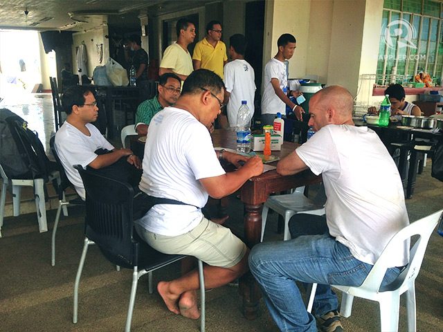 Day 6. Fr Lito Maraya (Seated 3rd from right), who is injured during Super Typhoon Yolanda, meets with other priests at Patmos inside the seminary complex, the humanitarian operations center of the Archdiocese of Palo. Photo by Voltaire Tupaz