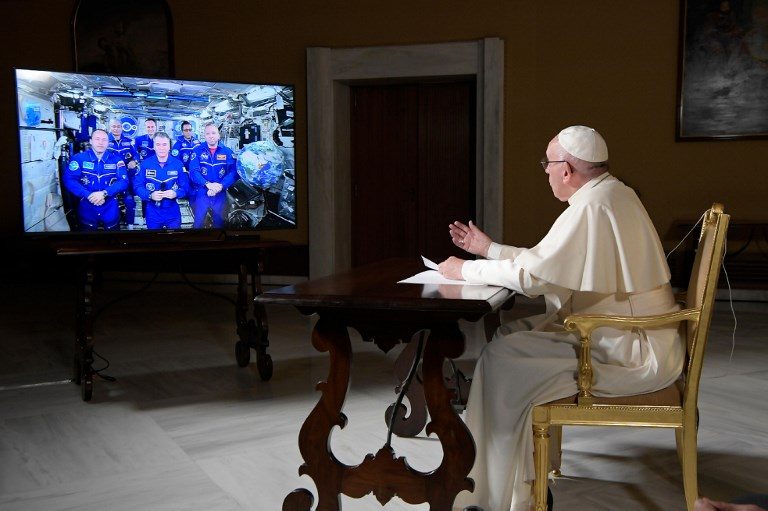 CHAT. Pope Francis (R) speaks during a video conference connection with the International Space Station (ISS), at the Vatican on October 26, 2017. Photo by 
Osservatore Romeno/AFP   