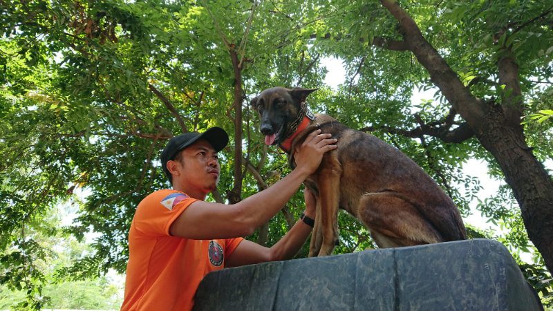 MAN'S BESTFRIEND. George Tomagan of the MMDA K-9 Corps poses with dog Vera during the first anniversay of 'Aso para kay Juan' DRR event. Photo by Renzo Acosta    