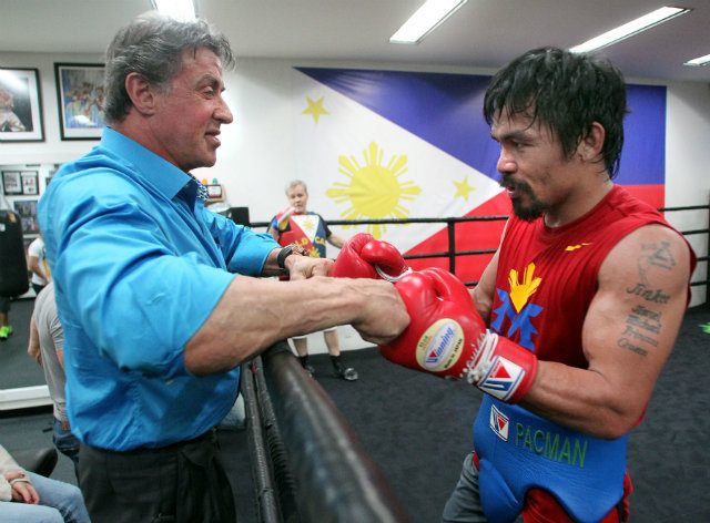 Stallone and Pacquiao touch fists before Pacquiao works the punch mitts. Photo by Chris Farina - Top Rank 