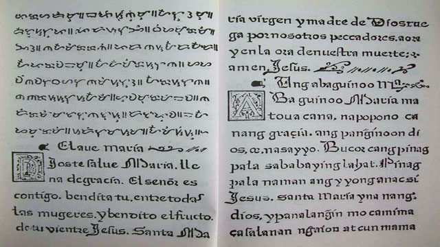 BILINGUAL EDUCATION. A copy of the Doctrina Christiana. Tagalog baybayin words occupy the upper left page while below it is the "Hail Mary" prayer in Spanish followed by its Tagalog translation, both in the Latin alphabet. Photo from Wikimedia Commons.