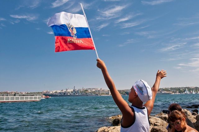BACK TO RUSSIA. In this file photo, a local boy waves a Russian flag during the annual Russian Navy Day parade in Sevastopol, Crimea, July 27, 2014. Anton Pedko/EPA
