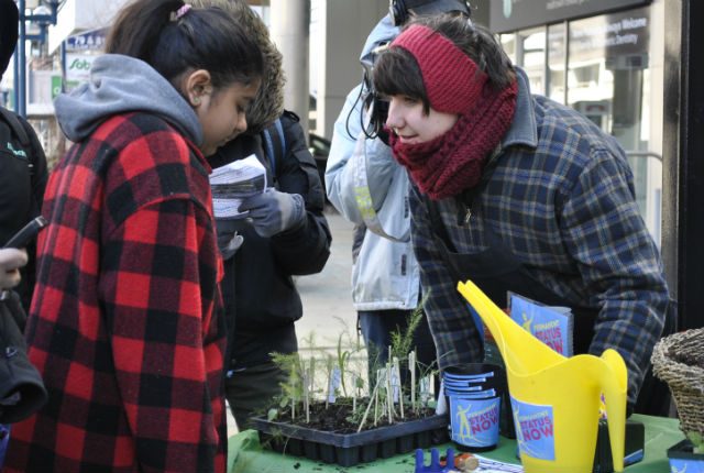 SEEDLINGS. Protestors and community members use plants to symbolize roots planted by migrant workers in Canada 