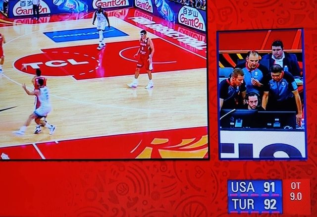 VETERAN. Bong Pascual (right) reviews a play from the USA-Turkey game with his fellow referees. Screenshot from FIBA  