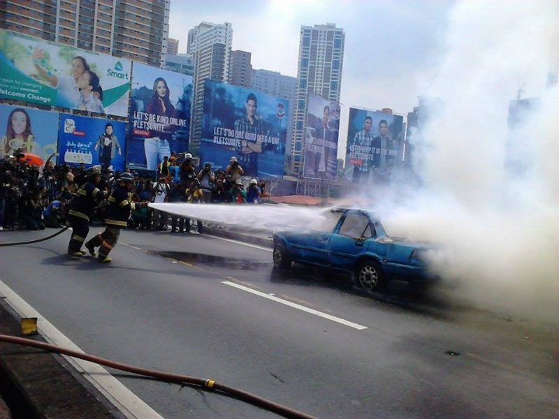 EARTHQUAKE SCENARIO. Firefighters attempt to extinguish a staged vehicular fire accident 