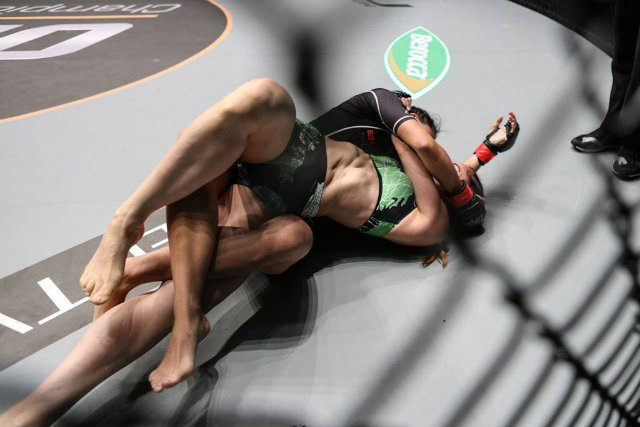 TWISTER. Angela Lee (in black) performs the twister submission on Fil-Aussie Natalie Gonzales Hills at ONE: Pride of Lions in Singapore. This is Lee's first-ever submission victory by twister. Photo from ONE Championship Facebook 