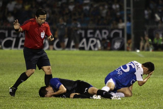 Reynald Villareal (L) and Phil Younghusband (R) lay on the pitch after colliding heads. Photo by Josh Albelda