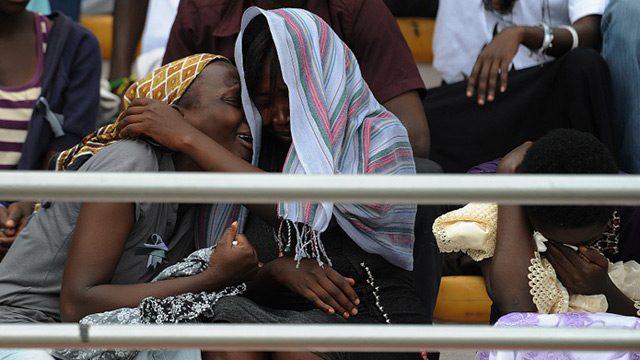 OVERCOME WITH EMOTIONS. Women cry at the Amahoro stadium in Kigali. Photo by Simon Maina/AFP