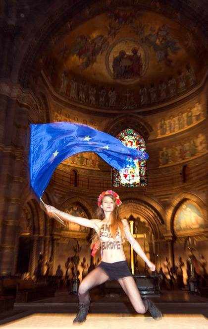 ‘ANTI-SECULAR EUROPE.’ A topless Femen activist protests in the Notre Dame of Strasbourg Cathedral in Strasbourg, France, saying the pope’s visit is not in line with the secularist principles of the EU. File photo by Patrick Seeger/EPA 