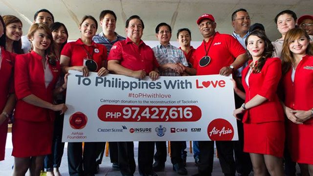 REHABILITATION EFFORT. AirAsia Group CEO Tony Fernandes (3rd from right) and Philippines Rehabilitation and Recovery Secretary Panfilo Lacson shake hands during the turnover ceremony held at Tacloban airport on Friday. Photo from AirAsia.
