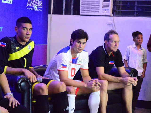 Phil Younghusband (C) shows off the new team kit as goalkeeper Neil Etheridge (L) and coach Thomas Dooley (R) sit at his side. Photo by Bob Guerrero 