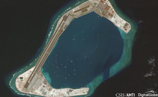 ZAMORA REEF. This satellite photo shows vessels inside the harbor of Zamora (Subi) Reef, reclaimed and built into a military base by China. Photo from AMTI-CSIS/DigitalGlobe 