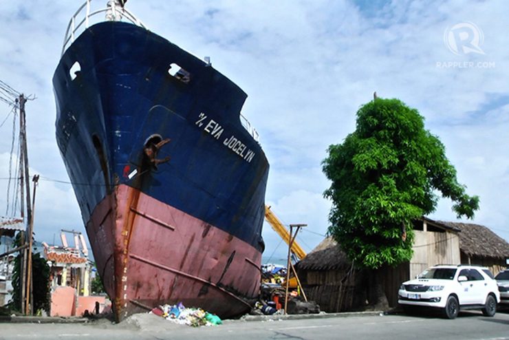 GRIM REMINDER. This grounded ship reminds passersby about Super Typhoon Yolanda (Haiyan) that killed residents in this danger zone. Photo by Franz Lopez/Rappler