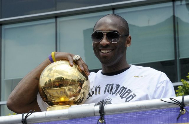 Kobe Bryant holds the Larry O'Brien Championship Trophy at the Lakers Victory Parade in 2010 after they defeated the Boston Celtics for the Lakers' second straight NBA title. It would be the last time Bryant is NBA champion. Photo by Mike Nelson/EPA 