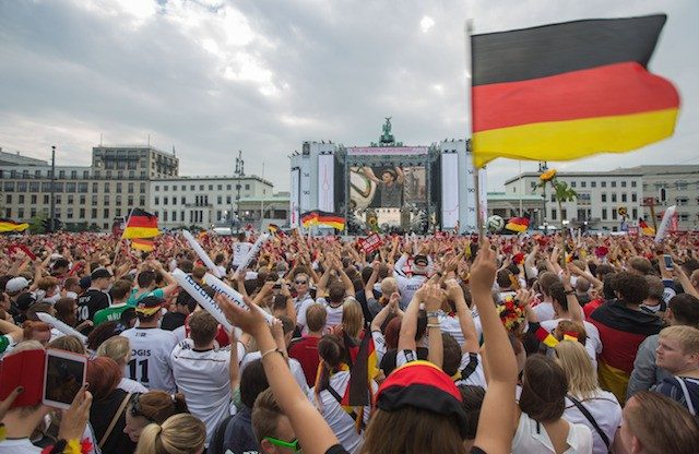 WAITING FOR THE CHAMPS. Supporters of the German national soccer team gather on the so-called 'Fan Mile' at the landmark Brandenburg Gate in Berlin, 15 July 2014 morning to wait for the return of the victorious team. Michael Kappeller/EPA