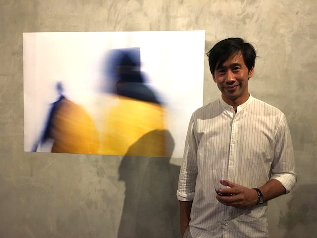 ALEX VILLALUZ. The Paris-based artist beside one of his works. Photo courtesy of Sandra Aguinaldo  