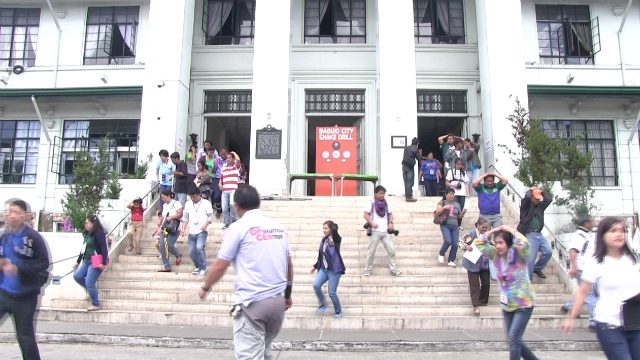 SHAKE DRILL. City hall employees evacuate the building during the city-wide earthquake drill. Photo by Rappler 